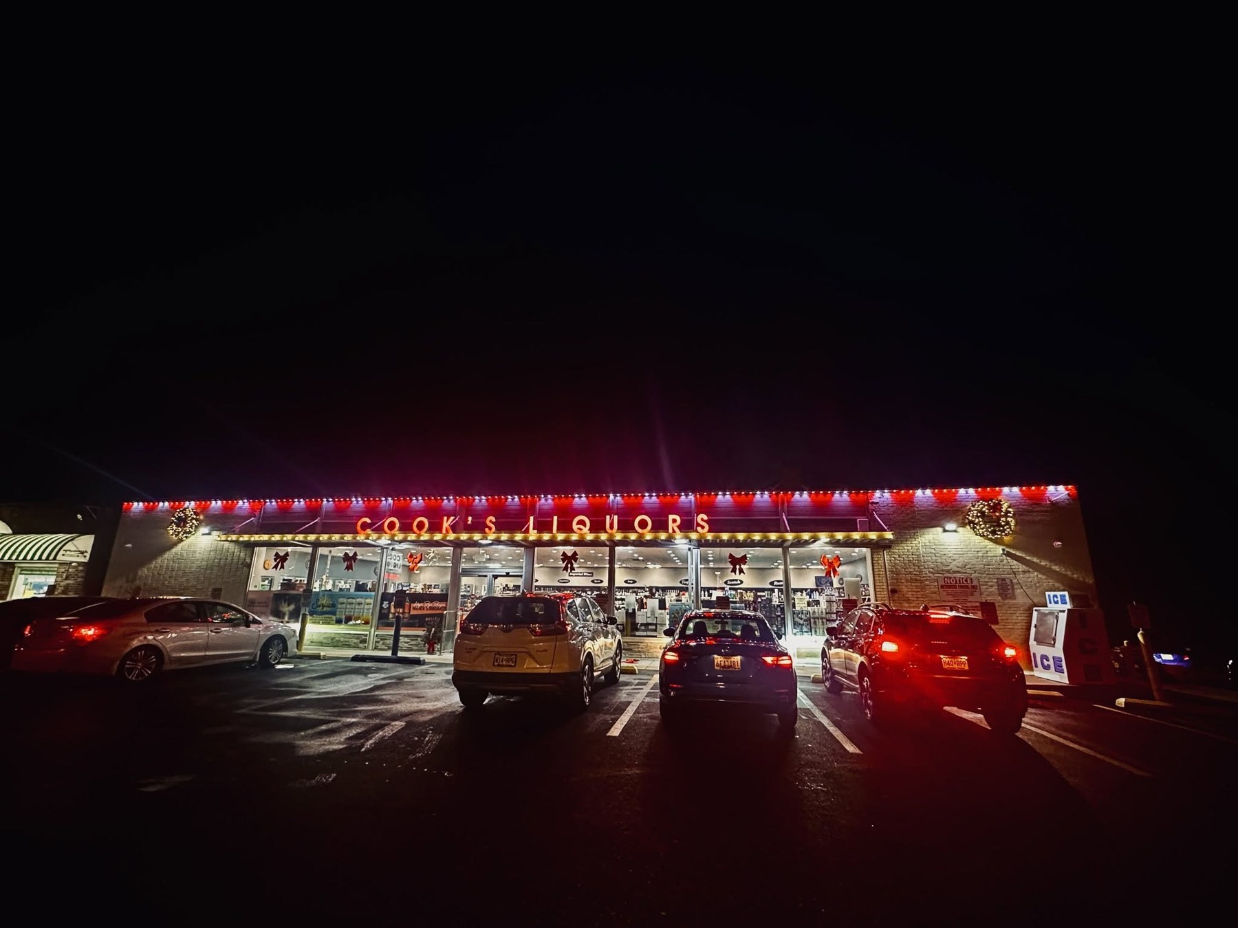 Commercial building with red and white permanent roofline lighting