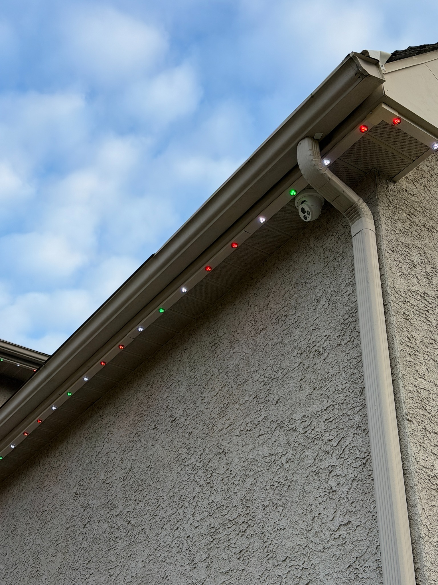 Professional permanent outdoor lights installed in a concealed color-matched track in South Jersey