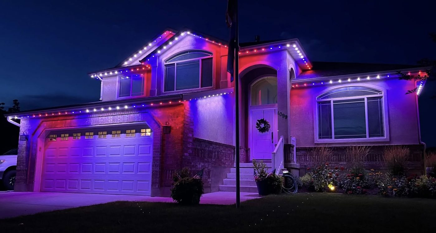 Home with permanent LED track lighting displaying red, white and blue for July 4th, installed by Cherry Hill Christmas Lights
